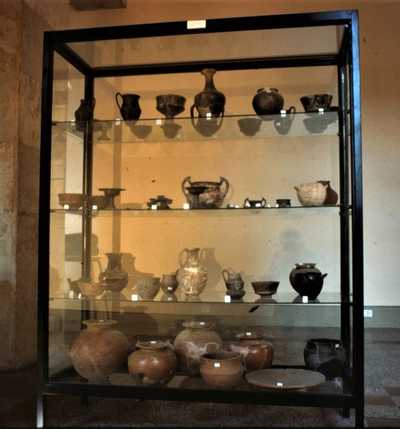 An old picture representing a display cabinet with different vases during the eighties